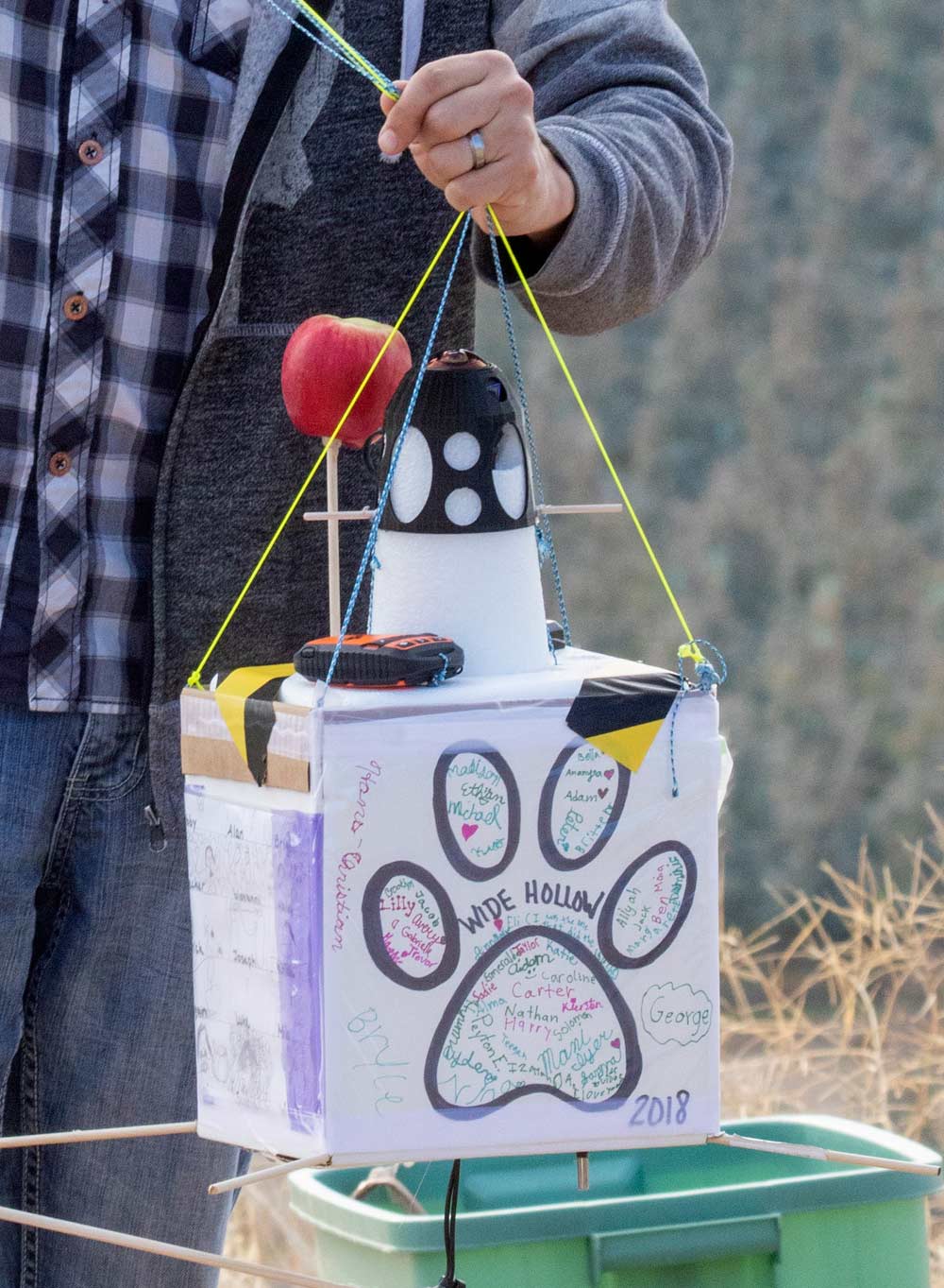 Before launch, Potter holds a fully assembled launch box that contains a 180-degree virtual reality camera and a freshly picked Autumn Glory apple. The apple ultimately flew about 20 miles above the earth. (TJ Mullinax/Good Fruit Grower)