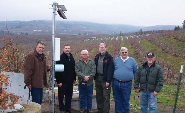 Pictured checking a new meter station are members of The Dalles Irrigation District’s Save Water Save Energy project planning team (from left): Tom Bailey, Tim Dahle, Mike Richardson, Lynn Long, Merlin Berg, and Casey Pink. Jac le Roux and Mike Omeg are not pictured.