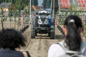 A driverless tractor creeps up a simulated orchard row during a robotics demonstration Sept. 20 at the FIRA USA agricultural automation conference and trade show in Salinas, California. (TJ Mullinax/Good Fruit Grower)