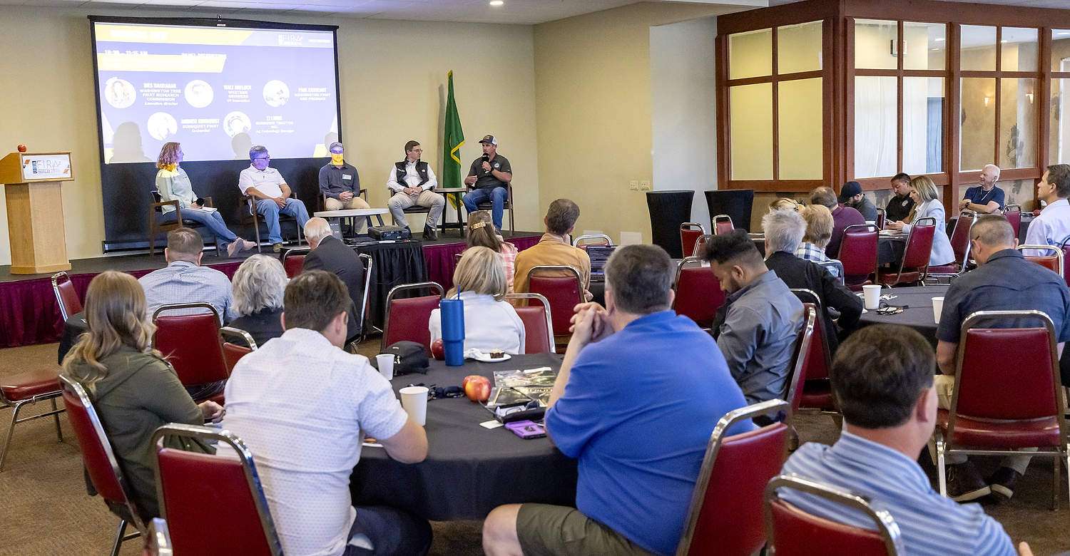 An industry panel discussed the importance of collaboration between tech companies and growers, including, from left: Ines Hanrahan, executive director of the Washington Tree Fruit Research Commission; Sam Godwin, a grower from North Central Washington; Paul Cathcart, an area manager for Washington Fruit Growers; Walt Duflock, vice president for innovation at Western Growers; and TJ Lange, ag technology manager for Burrows Tractor. (TJ Mullinax/Good Fruit Grower)