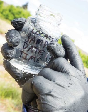 Chase shows the proper level of air space that should remain in a testing container when sampling water. The inside of sampling containers must not come in contact with possible contaminants, such as equipment or foliage. Also, don’t touch the inside of the bottle or cap. (TJ Mullinax/Good Fruit Grower)