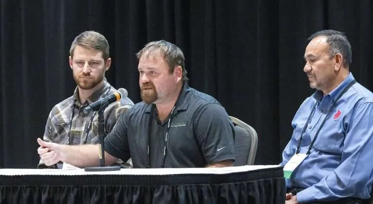 Adam Zediker of Columbia Farm Services speaks about the importance of training people well and making careful decisions about overtime during the Washington State Tree Fruit Association Annual Meeting in December at the Wenatchee Convention Center in Wenatchee, Washington. He’s joined on the panel by Gilbert Plath of Washington Fruit Growers, left, and Jose Ramirez of KS Orchard and El Paraiso Orchard, right. (Ross Courtney/Good Fruit Grower)