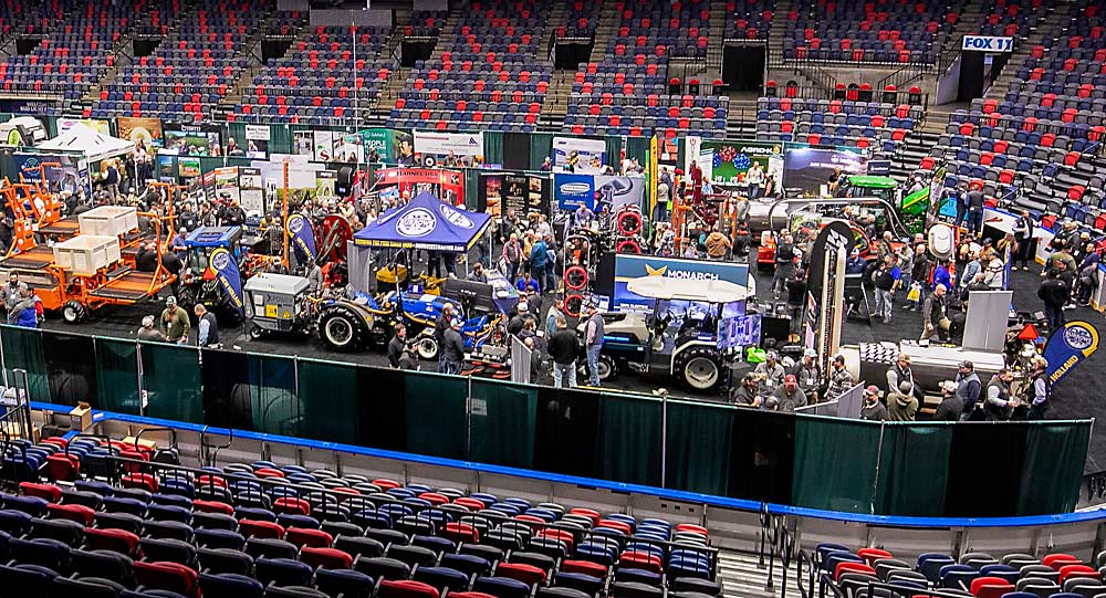 Burrows Tractor and other vendors display automation tools in December 2023 at the NW Hort Expo, held alongside the Washington State Tree Fruit Association’s annual meeting in Kennewick, Washington. (TJ Mullinax/Good Fruit Grower)