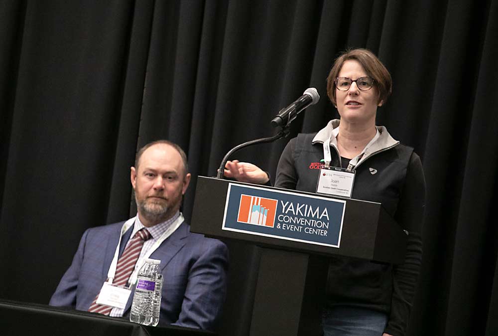 Joan Hebb, right, tree fruit coordinator with the Scotian Gold Cooperative and a board member of the International Fruit Tree Association, shares an update on the winter season in Nova Scotia on Monday, Feb. 12 as part of a regional roundtable kicking off the annual conference held this year in Yakima, Washington. Craig Tanner, current IFTA board chair, is seated at left. (TJ Mullinax/Good Fruit Grower)