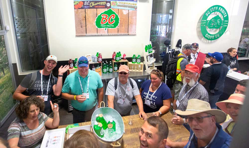BC Tree Fruits Cider staff member, Delphine Maja, bottom left, tries to keep IFTA attendees attention while giving a group tasting at the company's new cider division on July 24, 2018 in Kelowna, B.C. (TJ Mullinax/Good Fruit Grower)