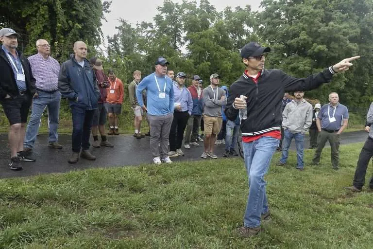 Cornell University entomologist Andres Antolinez with growers in an orchard