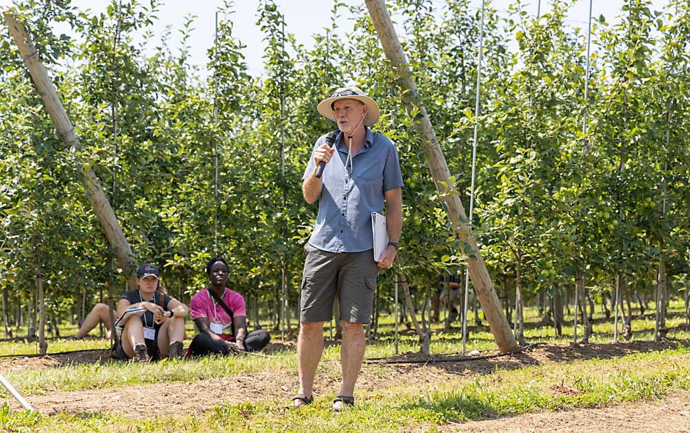 Soil scientist Keith Fuller speaks in a Nova Scotia orchard in July 2023, during an International Fruit Tree Association tour. Since Nova Scotia growers lost access to the preplant fumigant Telone about a decade ago, they’ve been seeking effective ways to manage apple replant disease. (Matt Milkovich/Good Fruit Grower)