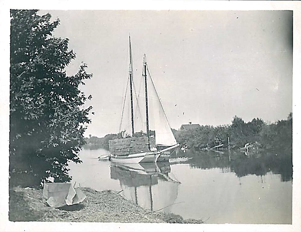 In this photograph from the early 20th century, a pear-laden schooner makes its way to San Francisco along Steamboat Slough, an alternate branch of the Sacramento River. (Courtesy Chuck Baker)