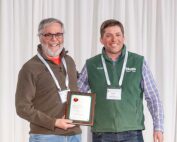 Jon Clements, left, was given the International Fruit Tree Association 2025 Industry Service Award by Massachusetts grower Andre Tougas during the association’s annual conference in February in Rochester, New York. (Matt Milkovich/Good Fruit Grower)