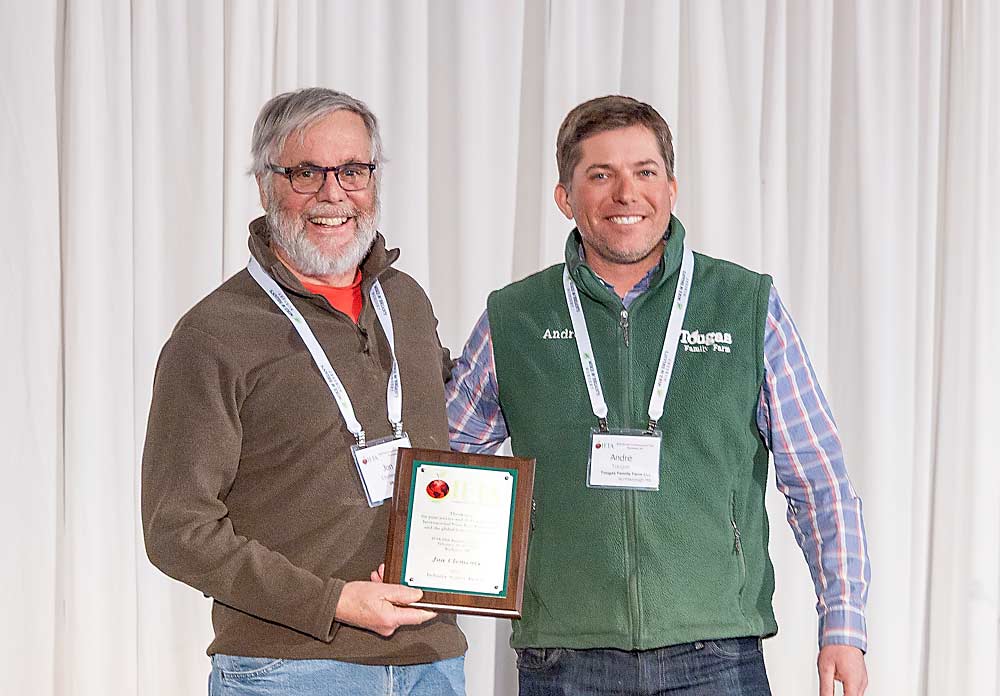 Jon Clements, left, was given the International Fruit Tree Association 2025 Industry Service Award by Massachusetts grower Andre Tougas during the association’s annual conference in February in Rochester, New York. (Matt Milkovich/Good Fruit Grower)