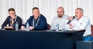 From left, growers Joel Crist, Patrick Dorsing, Justin Finkler and Chalmers Carr discuss economic decision-making during the International Fruit Tree Association’s winter conference in Rochester, New York, in February. (Matt Milkovich/Good Fruit Grower)