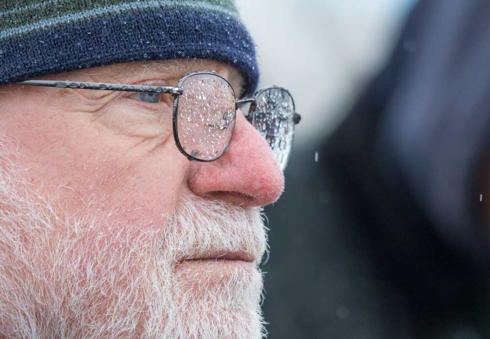 New York grower Joe Nicholson bears the freezing rain shortly after departing the IFTA bus at a stop at Washington at Auvil Fruit Co. in Orondo. <b> (TJ Mullinax/Good Fruit Grower)</b>