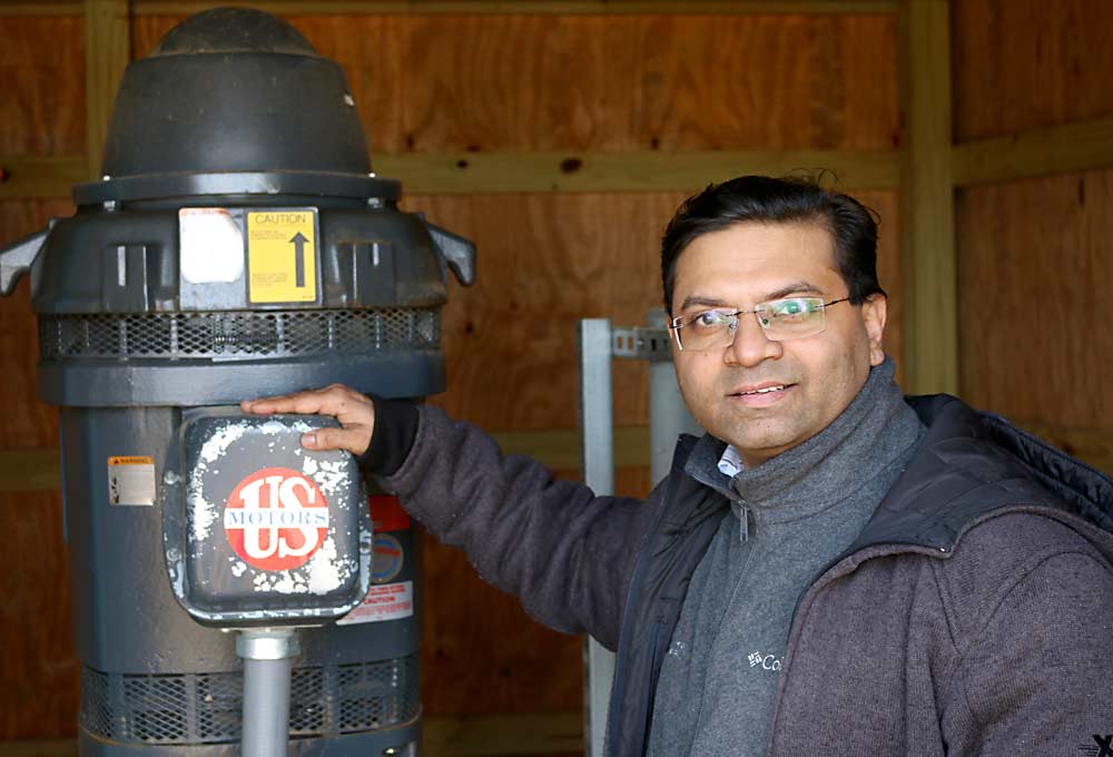 Hemant Gohil, wine grape and fruit extension agent at Rutgers University’s New Jersey Agricultural Experiment Station in New Brunswick, stands with a commercial U.S. Motors irrigation pump. Gohil says irrigation can encourage healthy apple trees to produce excellent fruit when done right. Determining the right pump capacity is a first crucial step toward establishing the irrigation system in a high-density orchard. (Courtesy Daniel Ward)