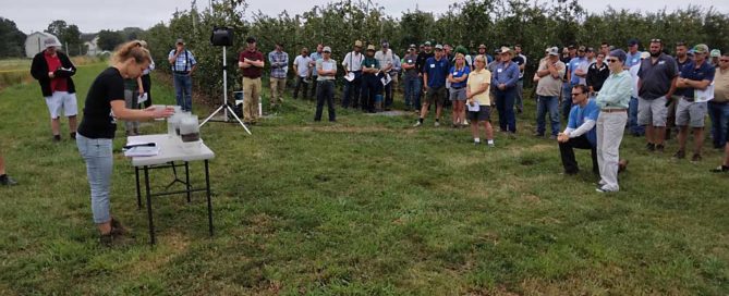 Cornell soil specialist Deborah Aller, left, displays soil sampling techniques during the Lake Ontario Fruit Program’s annual summer tour in Orleans County, New York. (Matt Milkovich/Good Fruit Grower)