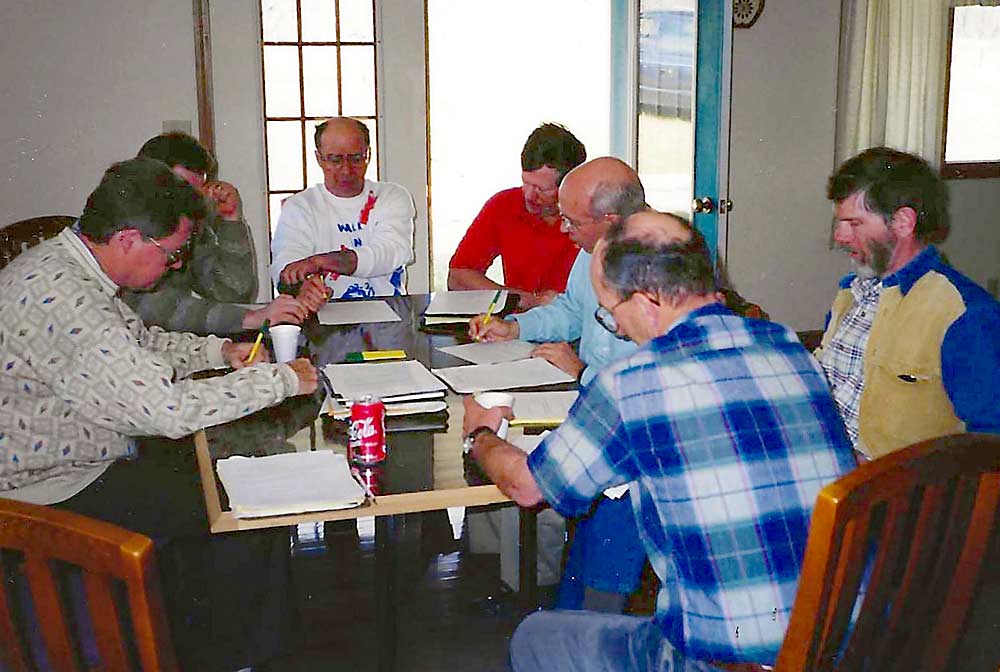 The Midwest Apple Improvement Association held its first board meeting at the Indiana home of co-founder Ed Fackler in March 1998. Clockwise, from left, are Jack Cruttenden, Gregg Bachman, Ed Fackler, Kevin Evans, Mitch Lynd, Steven Doud and Doug Shefelbine. (Courtesy David Doud)