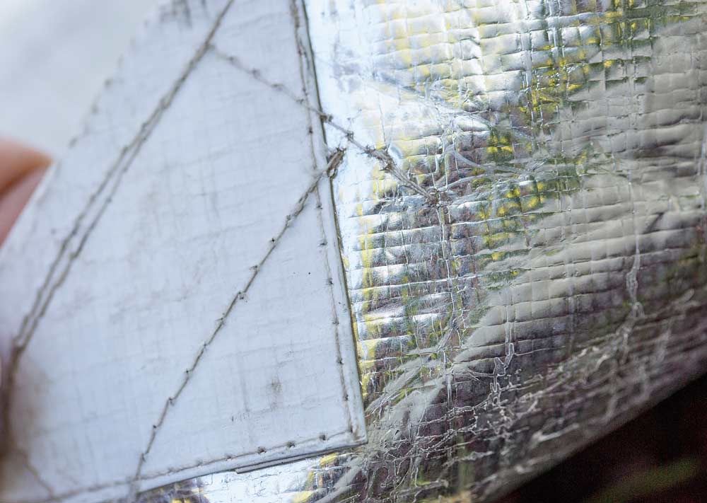 The mylar and white weave of a Bushpro cover used by many cherry growers in British Columbia's Okanagan Valley, on July 21, 2018. (TJ Mullinax/Good Fruit Grower)