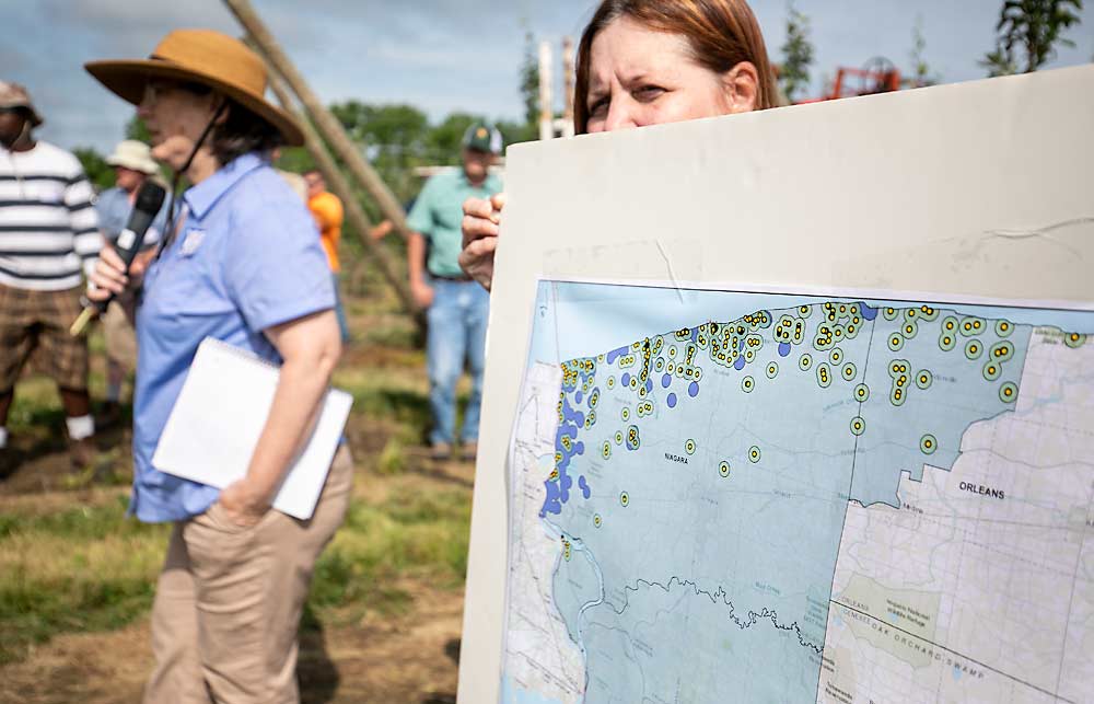 Margaret Kelly, left, shows an updated map showing 2019 trap findings of European cherry fruit fly in New York including the commercial cherry quarantine areas of Niagara, Erie and portions of Orleans counties on July 18, 2019. (TJ Mullinax/Good Fruit Grower)