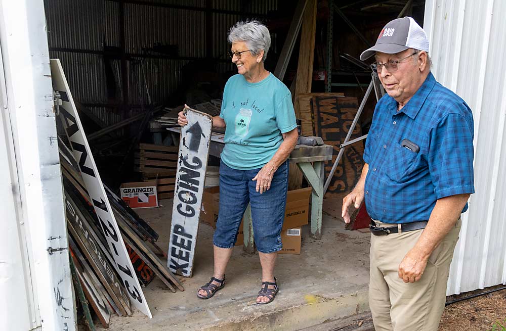 Mitch Lynd and his wife, Penny, share a laugh over their “Keep Going” signs that help direct customers. Mitch called the signs “the best idea ever” for a U-pick orchard. (Matt Milkovich/Good Fruit Grower)