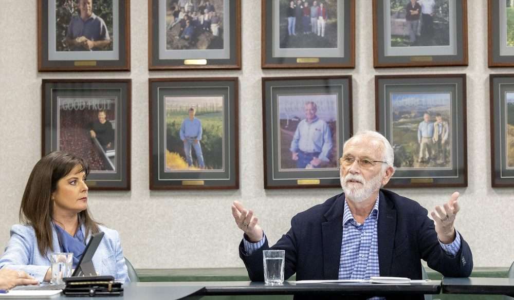 Washington Congressman Dan Newhouse, right, talks with Germaine Etcheverry Newstead of Good Fruit Grower magazine and other tree fruit industry representa-tives in Yakima on May 7, 2026. (TJ Mullinax/Good Fruit Grower)