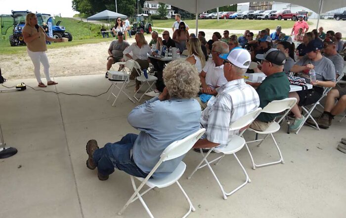 Kari Soldaat, left, of Riveridge Produce discusses the Apple Consumption Project with attendees at RidgeFest 2024 in Fremont, Michigan, on Aug. 1. The project is a new, nationwide effort to increase domestic apple consumption. (Matt Milkovich/Good Fruit Grower)