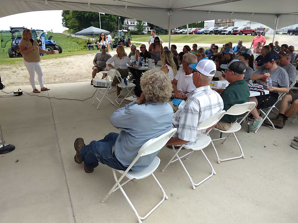 Kari Soldaat, left, of Riveridge Produce discusses the Apple Consumption Project with attendees at RidgeFest 2024 in Fremont, Michigan, on Aug. 1. The project is a new, nationwide effort to increase domestic apple consumption. (Matt Milkovich/Good Fruit Grower)