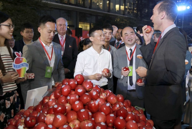 Jack Ma, in white, and Washington Apple Commission Shanghai rep Victor Want, right, during Alibaba’s T-Mall.com "Singles Day" celebration. <b>(Courtesy Washington Apple Commission)</b>