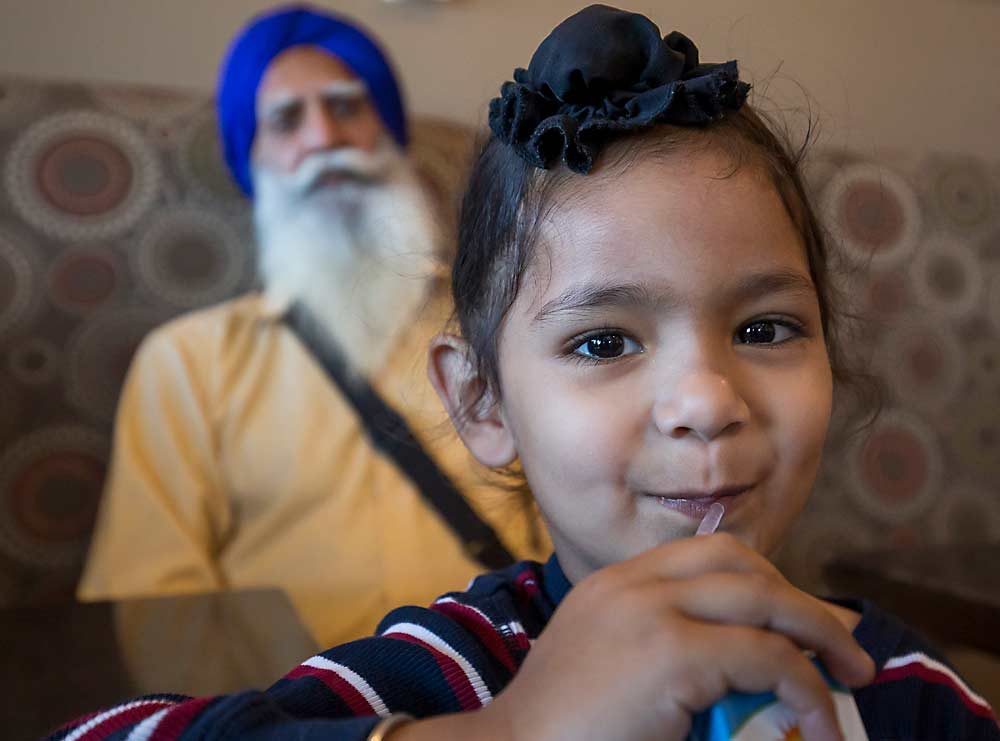 Bal’s son, Mehtaab Bal, 3, and his father-in-law, Machhar Singh, at Hillcrest Café. Singh was visiting from India. (TJ Mullinax/Good Fruit Grower)