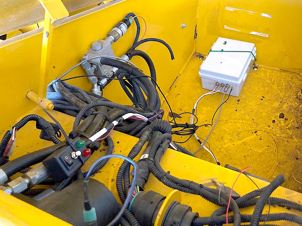 A plastic box contains a computer that is attached to the harvest receiver and records time and location data provided by the proximity sensor and GNSS antenna. (Courtesy Anderson Safre/Utah State University)
