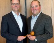 Immediate Past Chair Steve Clement, left, hands the gavel to Brett Baker, the new chair of the U.S. Apple Association’s board of directors. (Courtesy U.S. Apple Association)