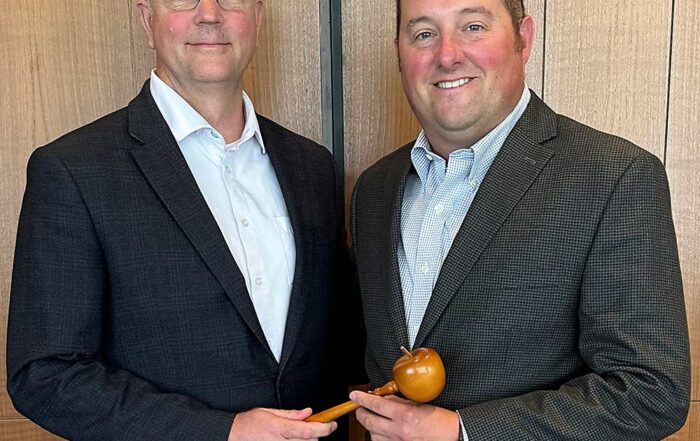 Immediate Past Chair Steve Clement, left, hands the gavel to Brett Baker, the new chair of the U.S. Apple Association’s board of directors. (Courtesy U.S. Apple Association)