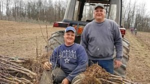 Twin Bee Orchard co-owner Tony Blattner and his son Nathan, left, take a break while planting 4,600 Smitten trees in spring 2016. Twin Bee, in west-central Michigan, has 135 acres of apples, including Gala, Red Delicious, Fuji, Honeycrisp, McIntosh, Empire, Ida Red and Jonagolds. (Courtesy Twin Bee Orchard LLC.)