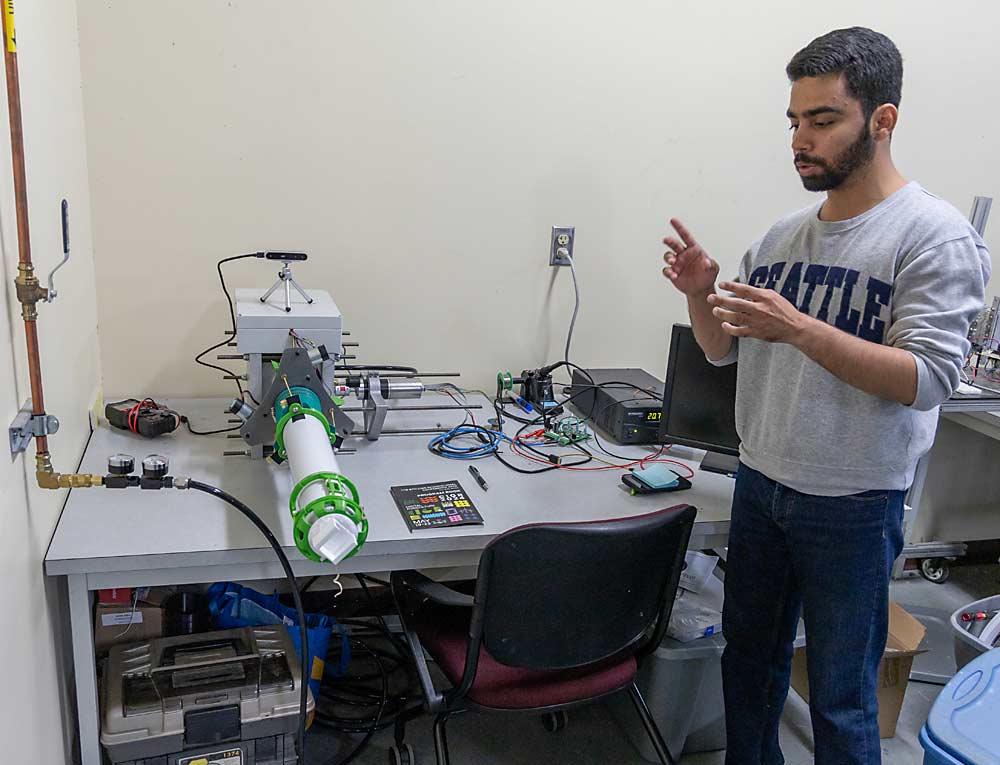 WSU research assistant Syed Usama Bin Sabir discusses a robotic orchard pruning arm covered in flexible fabric, a newer concept being developed at the Center for Precision and Automated Agricultural Systems. (Matt Milkovich/Good Fruit Grower)