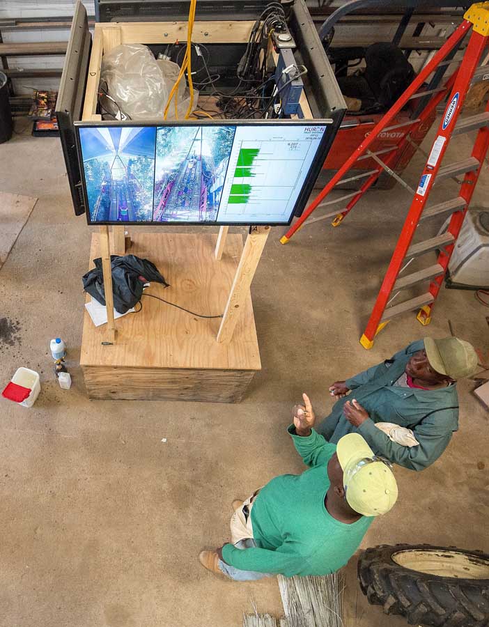 Apple thinning crews look over Huron Fruit Systems video and thinning speed data before heading out to work the morning of July 1, 2016. <b>(TJ Mullinax/Good Fruit Grower)</b>