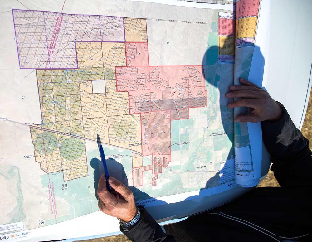 Tim Weidert shows the map of Weidert Farm near Touchet, Washington, highlighting potential growing zones and the current wind drainage of the property on September 29, 2017. This site is part of over 6,000 acres for sale by Weidert. <b>(TJ Mullinax/Good Fruit Grower)</b>