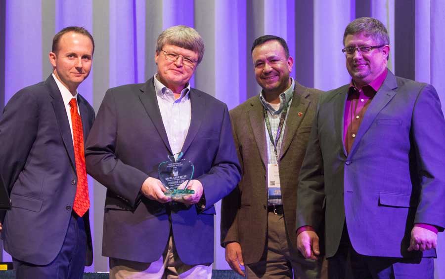 Mike Robinson is presented with Silver Apple Award during the 112th Annual Meeting and Northwest Hort Expo banquet on December 6, 2016 in Wenatchee, Washington. From left, West Mathison, Robinson, José Ramirez and Sam Godwin. <b>(TJ Mullinax/Good Fruit Grower)</b>
