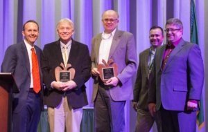 Charlie Pomianek and Kirk Mayer is presented with Distinguished Service Awards during the 112th Annual Meeting and Northwest Hort Expo banquet on December 6, 2016 in Wenatchee, Washington. From left, West Mathisson, Pomianek, Mayer, José Ramirez and Sam Godwin. (TJ Mullinax/Good Fruit Grower)