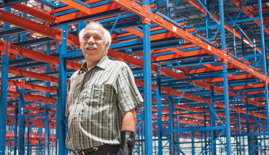 Ron Gonsalves, Blue Bird President, stands amid the rack storage of a warehouse that survived a wildfire in Wenatchee, Washington. (Shannon Dininny/Good Fruit Grower)
