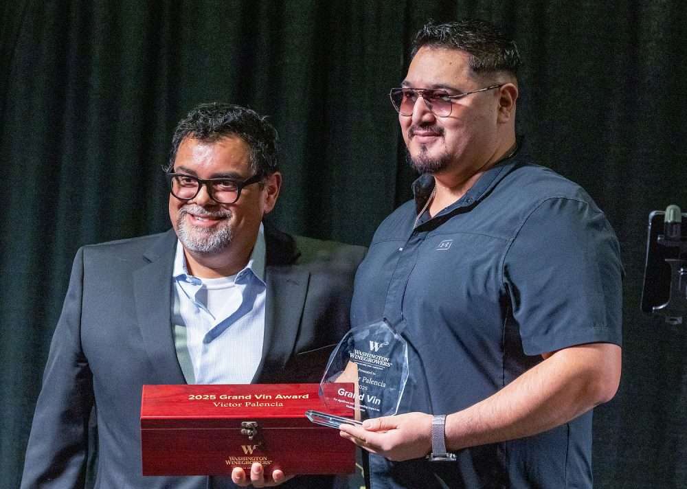 Victor Palencia, right, winemaker and CEO of Monarcha Winery, receives the Washington wine industry’s Grand Vin Award. (TJ Mullinax/Good Fruit Grower)
