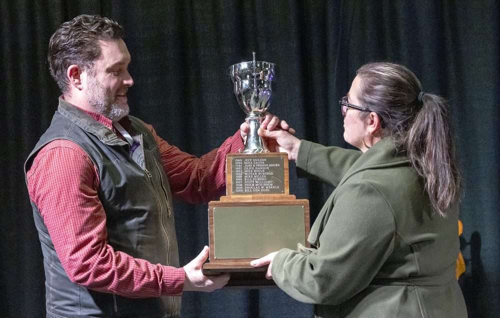 Ryan Flanagan, left, accepts the Washington wine industry’s Erick Hanson Memorial Grower of the Year Award at the Washington Wine Industry Foundation’s Party + Auction event on Feb. 10 at the Three Rivers Convention Center in Kennewick. (TJ Mullinax/Good Fruit Grower)