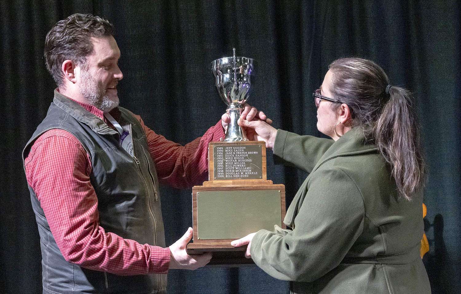 Ryan Flanagan, left, accepts the Washington wine industry’s Erick Hanson Memorial Grower of the Year Award at the Washington Wine Industry Foundation’s Party + Auction event on Feb. 10 at the Three Rivers Convention Center in Kennewick. (TJ Mullinax/Good Fruit Grower)
