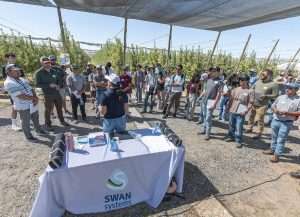 Alejandra Odegard of Swan Systems discusses automated irrigation in July with attendees at the Washington State University Smart Orchard field day in Mattawa.