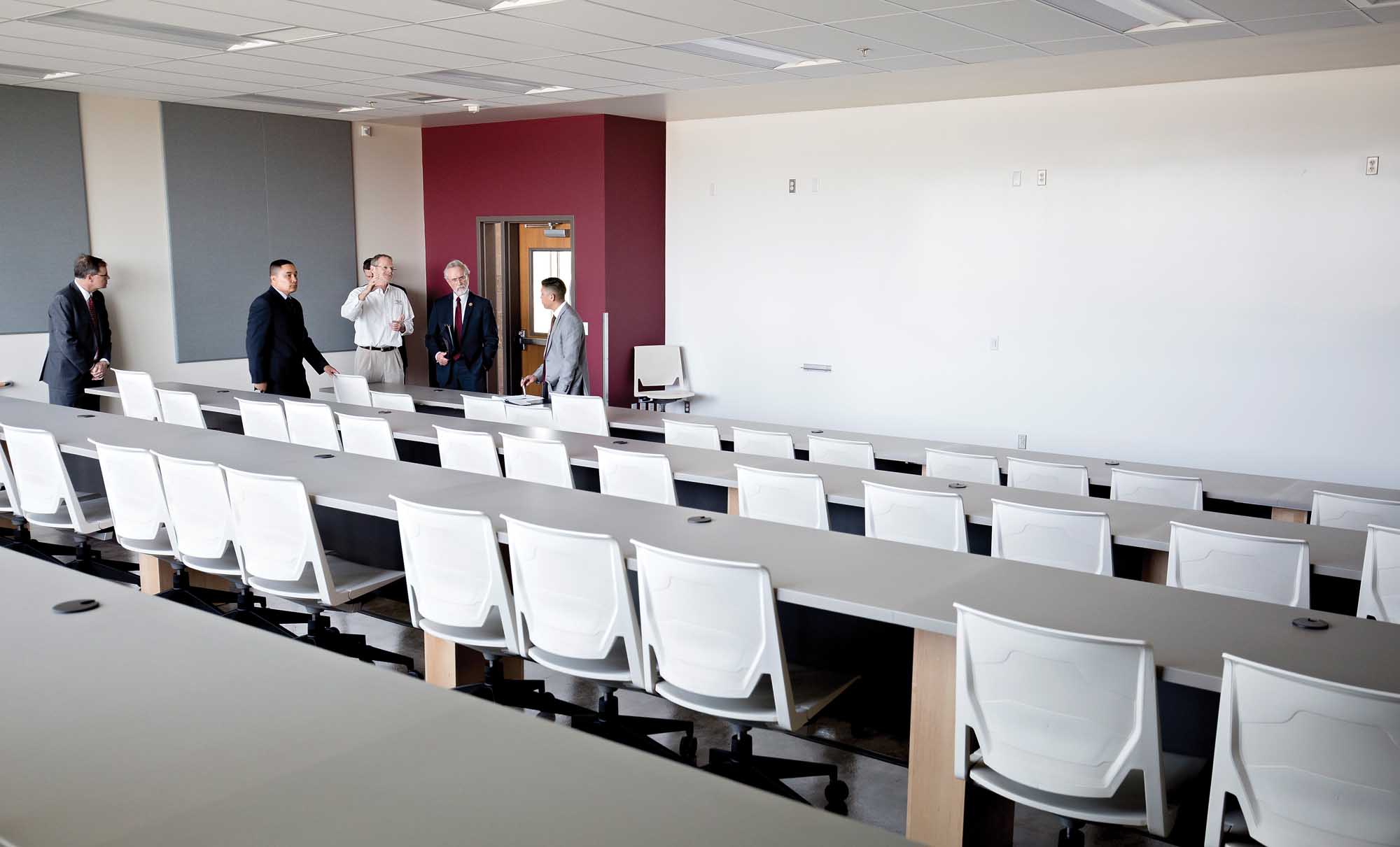Thomas Henick-Kling, wearing white, leads a tour of the new Washington State University Wine Science Center to U.S. Rep. Dan Newhouse on May 4, 2015. This room offers live video conferencing for students to evaluate wine between educational institutions, growers and winemakers across the globe.(TJ Mullinax/Good Fruit Grower)