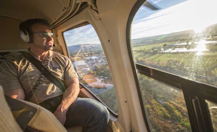 Mark Zirkle looks out over Selah after taking off from the Zirkle main office on his way to check on the apple harvest in Mattawa in late September. With ranches scattered up and down the state, Zirkle can substantially cut down travel time by commuting by air to monitor crops, projects and ongoing ranch upkeep during critical times in the season. <b>(TJ Mullinax/Good Fruit Grower)<b>